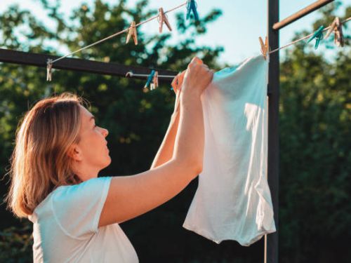 Woman hanging laundry on a washing line