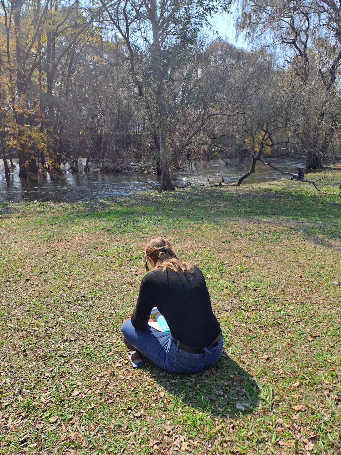 Students reading quietly beside a river during Equilibria’s Christian discipleship program