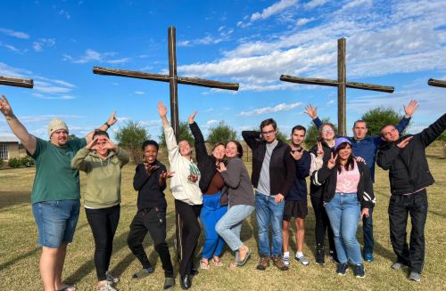 Equilibria gap year program students standing beside wooden crosses